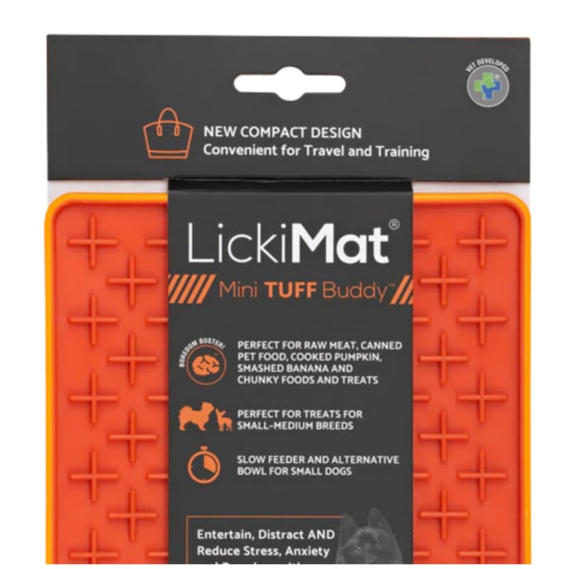Gros plan du LickiMat Mini Tuff Buddy Orange montrant la surface texturée en forme de croix pour éta