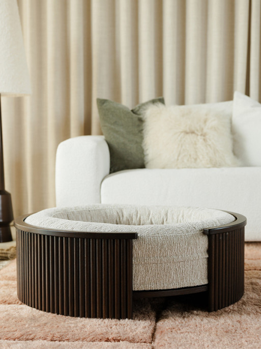 Fantail 1083708 walnut wood dog bed frame in a bedroom, showing size relative to furniture.