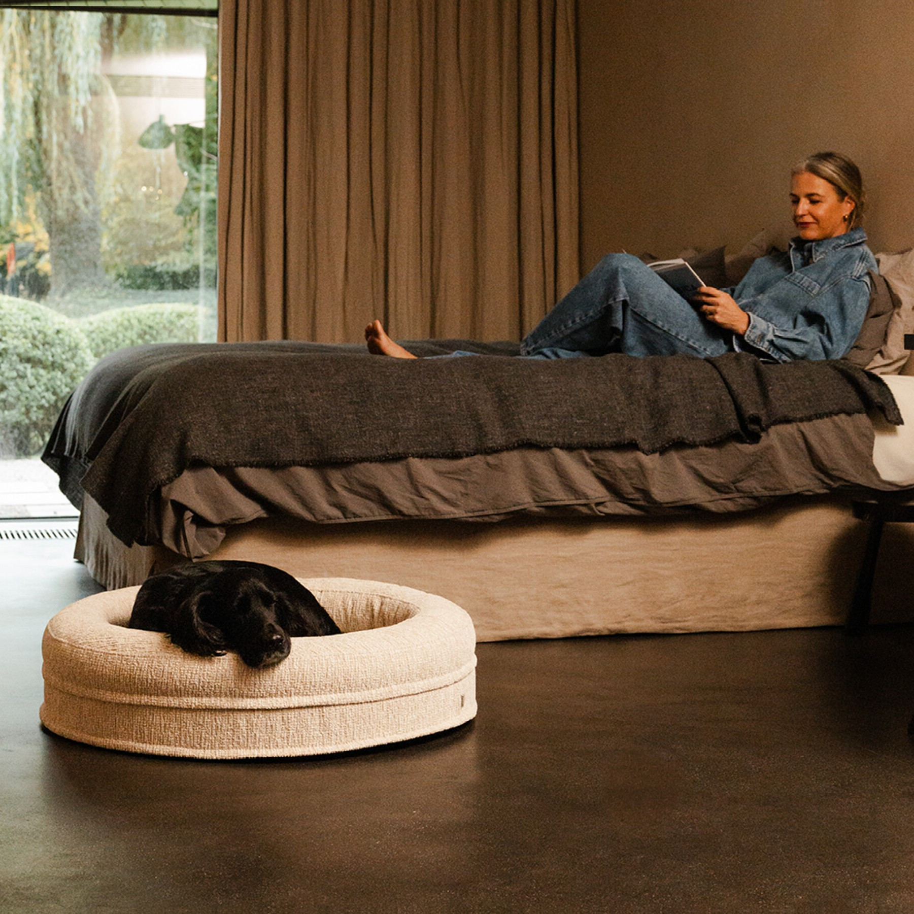 A dog comfortably resting on the Fantail Elite Clay orthopedic bed, enjoying the memory foam support