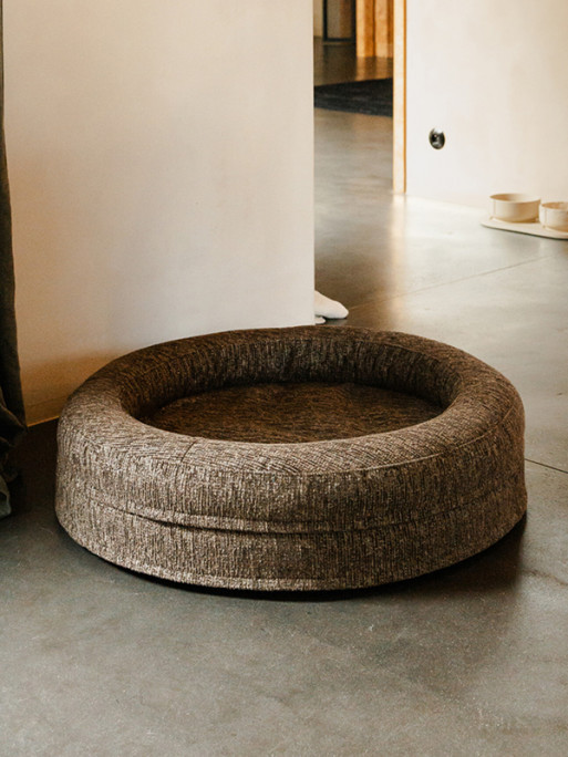 Fantail Elite Pouf Expresso orthopedic dog bed in a cozy living room setting with a dog resting comf